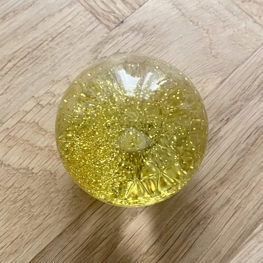 Sensoriska glitterbollar 1 st. - TickiT - Gul